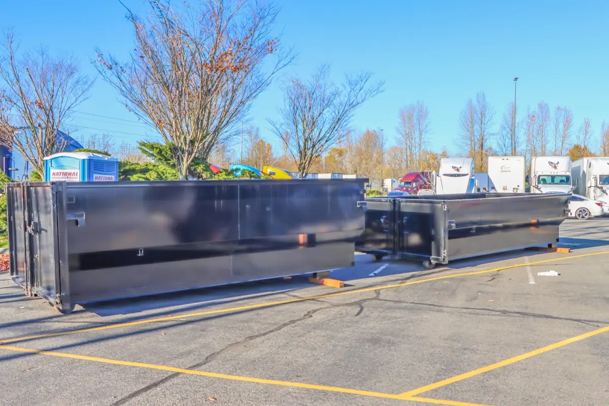 Professional dumpster rental service with roll-off container on residential driveway in Palestine